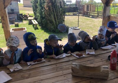 Dzieci wspólnie spożywają posiłek przy stole.